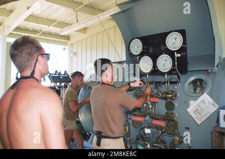 Members of Underwater Construction Team Two (UCT-2) train on running a recompression chamber at the Pacific Missile Range Facility at Kauai, Hawaii.(Exact date unknown). Country: Pacific Ocean (POC) Stock Photo