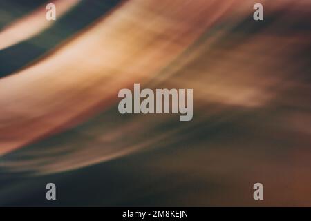 Wavy abstract dirty brown background in warm colors as a curtain with a light. Backdrop Stock Photo
