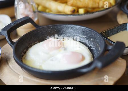 fried eggs in a frying pan Stock Photo