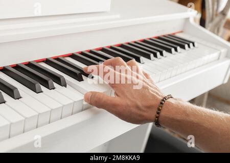Male pianist hands on piano keyboard Stock Photo