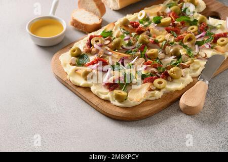 Homemade trendy Butterboard with onion, garlic, orange, herbs , crispy baguette and toasts on gray background. Close up. Stock Photo