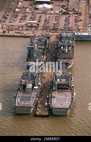 An aerial stern view of four navy ships tied up at destroyer and submarine (D&S) pier 20 at the Naval base. On the north side of the pier is the fleet oiler USS Platte (AO-186) with the amphibious transport dock USS Ponce (LPD-15) astern of her. South side of the pier is the destroyer tender USS Shenandoah (AD-44) with the dock landing ship USS Ashland (LSD-48) astern of her. Base: Naval Air Station, Norfolk State: Virginia (VA) Country: United States Of America (USA) Stock Photo