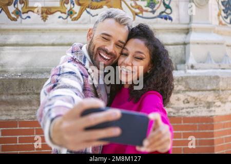A young couple, taking selfies, making funny faces Stock Photo