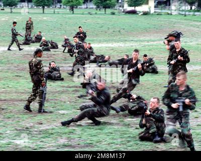 A Royal Thai Army Infantry Soldier gives firing position and combat maneuver instructions to US Army Soldiers from Charlie Company, 2nd Battalion, 1ST Infantry division, Fort Wainwright, Alaska, during the cross training phase of Exercise Cobra Gold '96. Subject Operation/Series: COBRA GOLD 96 Base: Fort Wainwright State: Alaska (AK) Country: United States Of America (USA) Scene Major Command Shown: 960504-M-7792H-005 Stock Photo