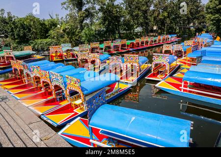 Colorful painted trajinera boats waiting for tourists to travel the ...