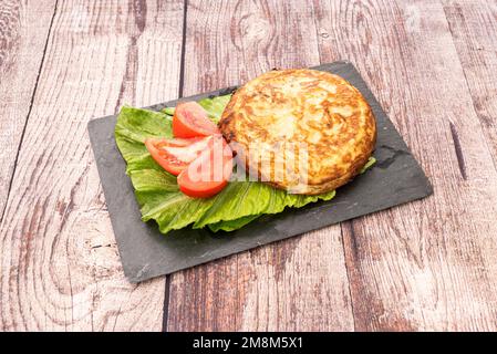 Tortilla de patatas is one of the most well-known and emblematic dishes of Spanish cuisine, being a very popular product that can be found in almost a Stock Photo