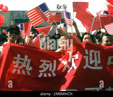 Chinese American civilians greet the People's Liberation Army (Navy) vessels, the Luhu Class Destroyer HARIBING (DDG 112), Luda II Class Destroyer, ZHUHAI (DDG 166), and a supply ship, the Fusu Class, NANYUN (AOR/AK 953) (Not shown), stopped at Naval Station, North Island, San Diego, California, on March 21st, 1997. This marks the first time Chinese warships have crossed the Pacific and visited the Continental United States. Base: Naval Air Station, North Island State: California (CA) Country: United States Of America (USA) Stock Photo
