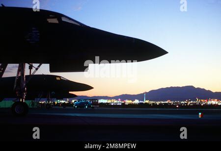 The noses of three B-1B bombers from the 28th Bomb Squadron, 7th Bomb Wing, Dyess Air Force Base, Texas, are silhouetted against the Las Vegas skyline during a RED FLAG exercise. Exact Date Shot Unknown. Base: Nellis Air Force Base State: Nevada (NV) Country: United States Of America (USA) Stock Photo