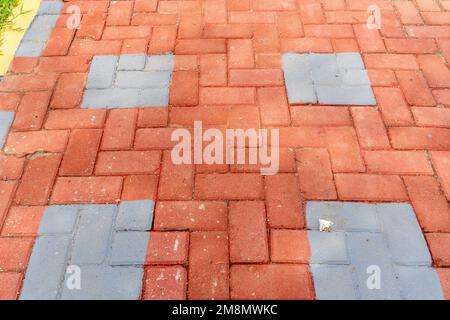 Orange colored paving block bricks path in the park close up Stock Photo