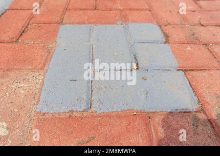 Orange colored paving block bricks path in the park close up Stock Photo