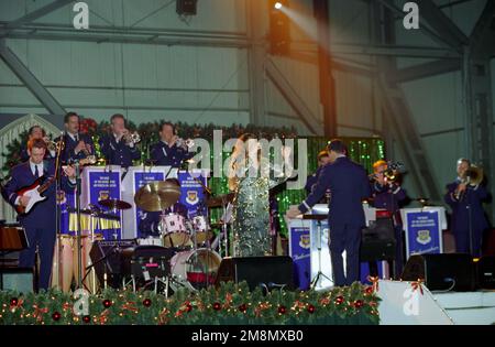 US Air Force (USAF) Technical Sergeant (TSGT) Verlei T. Virgil (center stage) accompanies the US Air Force in Europe (USAFE) Band, during a concert performance titled 'Operation SEASONS GREETINGS '97'. Base: Incirlik Air Base, Adana Country: Turkey (TUR) Stock Photo