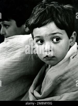 Military Photographer of the Year Winner 1998 Title: Eyes of Fear Category: News Place: First Place NewsSeth Horstman, 4 years old, and his brother Ross wait for the firemen to put out the fire at their neighbor's home in the cool early morning hours of April. A fire broke out in base housing at Fort Meade, Md., due to faulty electrical wiring in the townhouse. The smoke from the fire forced residents of four other units to leave their homes. Seth is the son of U.S. Air Force STAFF SGT. Robert Horstman. Country: Unknown Stock Photo