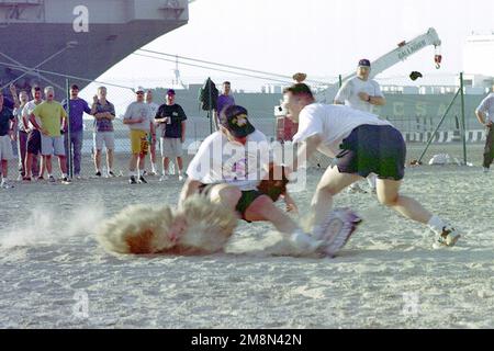 US Navy Lieutenant (LT) Todd Zirkle tags a base runner out during the nuclear powered aircraft carrier USS JOHN C. STENNIS (CVN 74) Officers versus CHIEF PETTY Officers softball game in Mina Jabal Ali, United Arab Emirates. The JOHN C. STENNIS is currently on a scheduled six month deployment to the Persian Gulf in support of Operation SOUTHERN WATCH, 9 May 1998. Subject Operation/Series: SOUTHERN WATCH Base: Jabal Ali Country: United Arab Emerites (UAE) Stock Photo