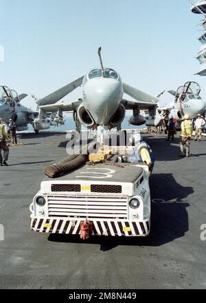 An Aviation Boatswain's Mate 3rd Class directs an F/A-18 Super Hornet ...