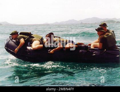 Marines from the US and Thailand hug the side of a combat rigid raider craft, or Zodiak boat, enroute to their beach landing site from USS DUBUQUE (LPD 8). The Royal Thai Marines joined their US counterparts from the 31st Marine Expeditionary Unit's Battalion Landing Team, 3rd Battalion, 5th Marines, for the boat raid portion of Exercise COBRA GOLD '98. Subject Operation/Series: COBRA GOLD '98 Country: South China Sea Stock Photo