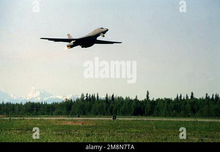 Right side medium shot from a low angle looking up at a USAF B1-B Lancer Long Range Bomber, taking off at Eielson Air Force Base, Alaska, during Coronet Yukon '98. The bomber is from the 116th Bomb Wing, Robins AFB, Georgia, and is deployed to Eielson for the exercise. Subject Operation/Series: CORONET YUKON '98 Base: Eielson Air Force Base State: Alaska (AK) Country: United States Of America (USA) Stock Photo