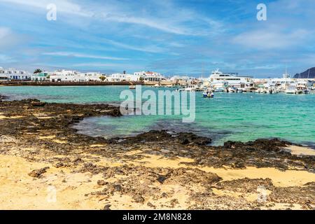 Beach and port with boats and ferries in Caleta del Sebo, La Graciosa, Canary Islands, Spain Stock Photo