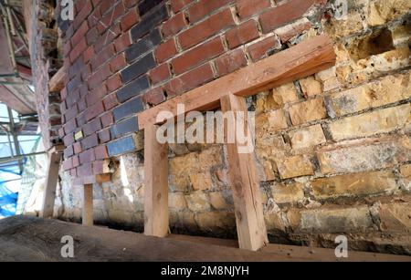 Rostock, Germany. 03rd Jan, 2023. On the facade of the water tower, parts of the facing masonry are being supported that have detached from the load-bearing masonry behind it. Renovation of the water tower, which was built in 1903, had begun in May 2018 and is scheduled to be completed in 2024 according to current plans. The tower, which is more than 40 meters high, has long had problems with moisture penetrating the masonry. Credit: Bernd Wüstneck/dpa/Alamy Live News Stock Photo