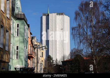 Rostock, Germany. 03rd Jan, 2023. The water tower has been stuck under a white tarp since renovation began in May 2018. According to the current plan, the renovation of the water tower, which was built in 1903, should be completed in 2024. The tower, which is more than 40 meters high, has long had problems with moisture seeping into the masonry. Credit: Bernd Wüstneck/dpa/Alamy Live News Stock Photo