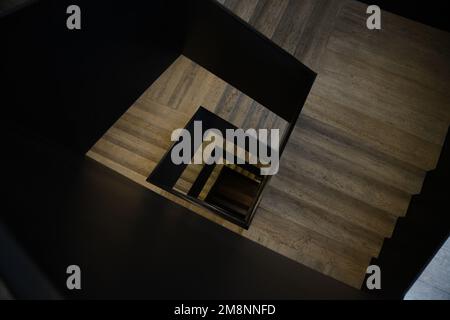 Spiral square staircase looked from down to up. Vintage staircase in old tenement house. Perspective view from bottom. High quality photo Stock Photo
