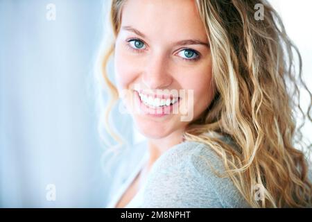 Free to be herself. A striking young blonde looking at you with a big smile - Copyspace. Stock Photo