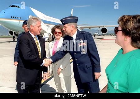 President William Jefferson Clinton shakes hands with US Air Force Brigadier General Jerry M. Drennan, Comander, 21st Space Wing, Peterson Air Force Base, Colorado, while his wife Bobbie looks on. This event took place on June 2nd, 1999. Air Force One is parked on the Peterson AFB flight line in the background. Base: Peterson Air Force Base State: Colorado (CO) Country: United States Of America (USA) Stock Photo