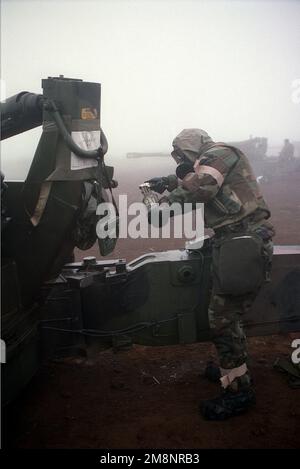 In Mission-Oriented Protective Posture response level 4 (MOPP-4) gear, SGT Vargasepinal from India Battery, 3rd Battalion, 12th Marines, Twenty-Nine Palms, California, uses an M11 to decontaminate an M198, 155 mm Howitzer, during Nuclear, Biological, Chemical (NBC) training operations at a camp near the base of Mount Fuji. Base: Mount Fuji Country: Japan (JPN) Stock Photo