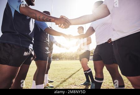 Two opponent rugby teams shaking hands before or after a match outside ...