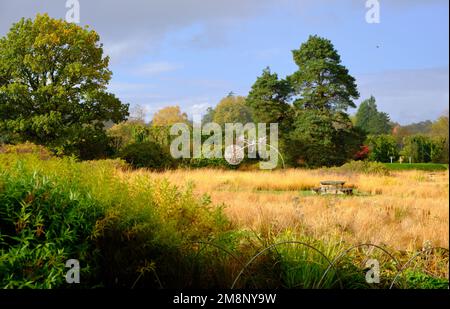 A scenic shot of Trentham Gardens with a fairy wire sculpture in the distance Stock Photo