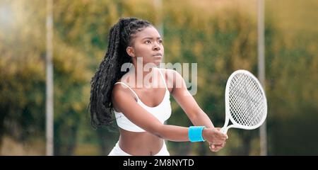 Focused tennis player waiting during a match. Young woman holding her tennis racket during a game. professional tennis player waiting to hit a ball Stock Photo