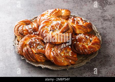Homemade tasty Kanelbulle the nordic cinnamon rolls close-up on a plate on the table. Horizontal Stock Photo