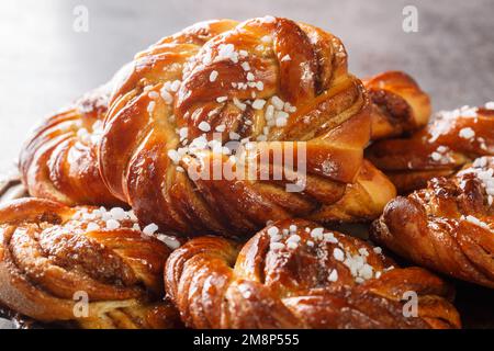Swedish kanelbullar cinnamon buns made with a perfectly soft and chewy cardamom dough, a buttery cinnamon-sugar filling, and twisted into cute little Stock Photo