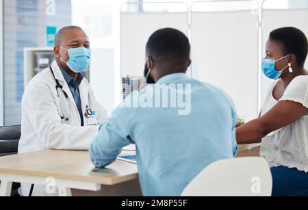 African american couple having a consult about fertility issues. Medical gp talking to a couple about covid results. Couple in a medical checkup for Stock Photo