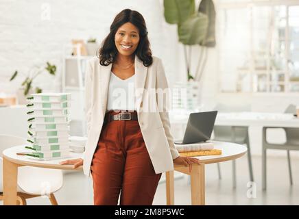 African american businesswoman leaning on her desk. Portrait of a young businesswoman in her office. Creative designer working in her agency. Powerful Stock Photo