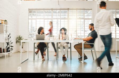 Group of businesspeople working in an office. Diverse group of businesspeople in a office. Diverse architects working together. Businesswomen talking Stock Photo
