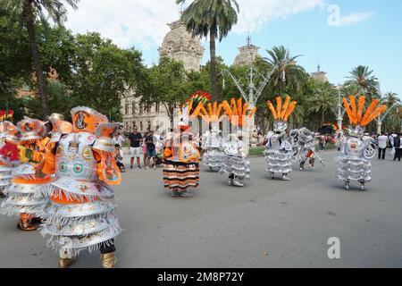 Bolivia folk dancers wearing costumes in silver and orange and  rich feather decoration on their heads. Stock Photo