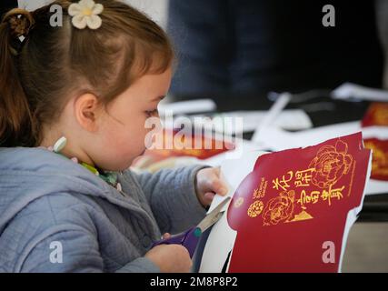 Ottawa, Canada. 14th Jan, 2023. A girl learns to make a red envelope at the Lunar New Year Market hosted by University of British Columbia (UBC) Botanical Garden in Vancouver, British Columbia, Canada, on Jan. 14, 2023. The festive event, hosted for the first time by UBC Botanical Garden, features artisan markets and various performances to welcome the Year of the Rabbit. Credit: Liang Sen/Xinhua/Alamy Live News Stock Photo