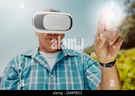Senior mixed race farmer using virtual reality headset to choose and select option with cgi. Hispanic elderly man planning with technology in Stock Photo