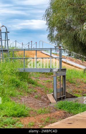 Part of the levee bank and a floodgate that protects the town of Nyngan from flooding from the Bogan River in northwest New South Wales, Australia Stock Photo