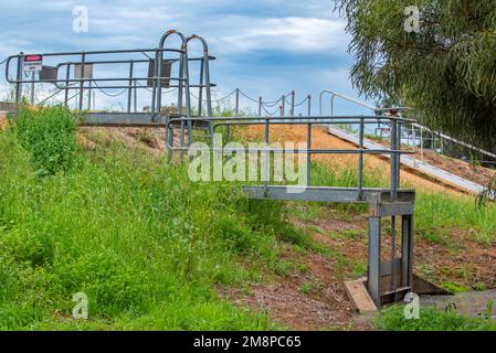 Part of the levee bank and a floodgate that protects the town of Nyngan from flooding from the Bogan River in northwest New South Wales, Australia Stock Photo