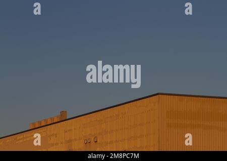 An abstract image of an orange, corrugated steel industrial building in Chuo Rinkan, Kanagawa, Japan. Stock Photo