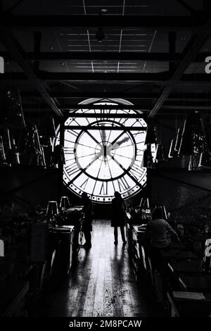 Paris, France - May 18, 2022: Giant clock of Musee d'Orsay with unidentified people. It houses in former Gare d'Orsay, a Beaux-Arts railway station Stock Photo