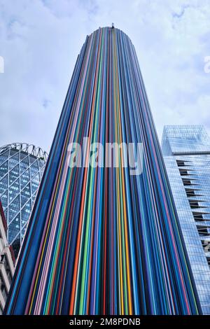 Paris, France - May, 2022: Colorful Moretti column in La Defense. The 30 m high sculpture -La Cheminee- with 700 color tubes was erected 1990 Stock Photo