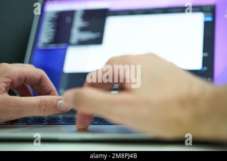 Hands in laptop coding and developing software Stock Photo