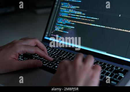 Programmer hands coding and developing software with html and javascript Stock Photo