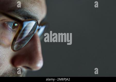 Lines of code reflected in glasses of software programmer and web developer Stock Photo