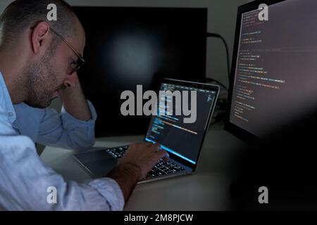 Tired programmer coding and developing software Stock Photo