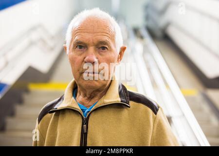 Portrait of old man going to metro station Stock Photo