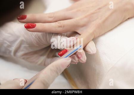 professional paint color red women's nails Stock Photo