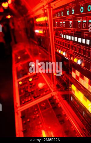 The interior of a modern railway control room with red electronic lights Stock Photo